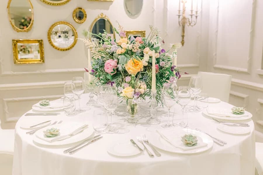 A long-table centrepiece running the length of a private dinner