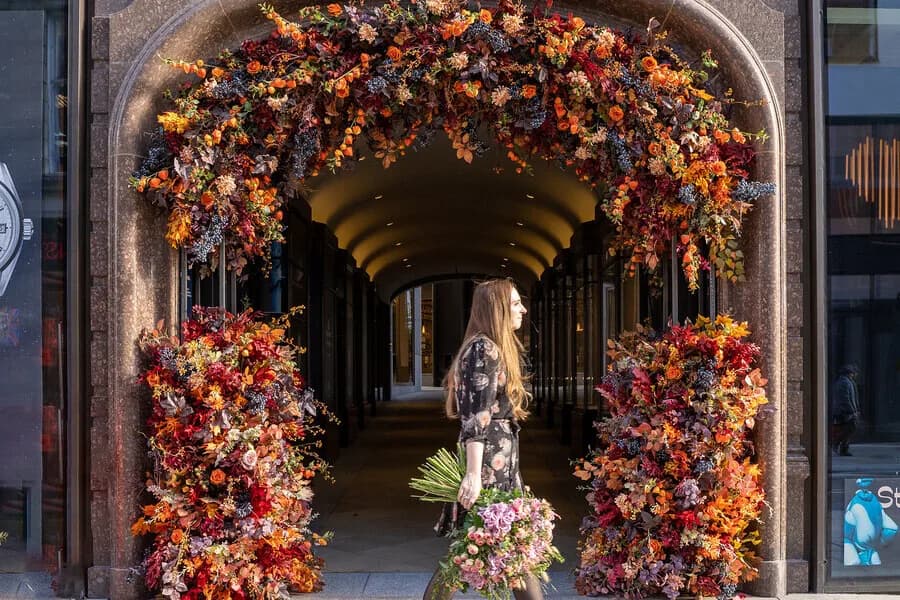 A large-scale floral installation forming an archway